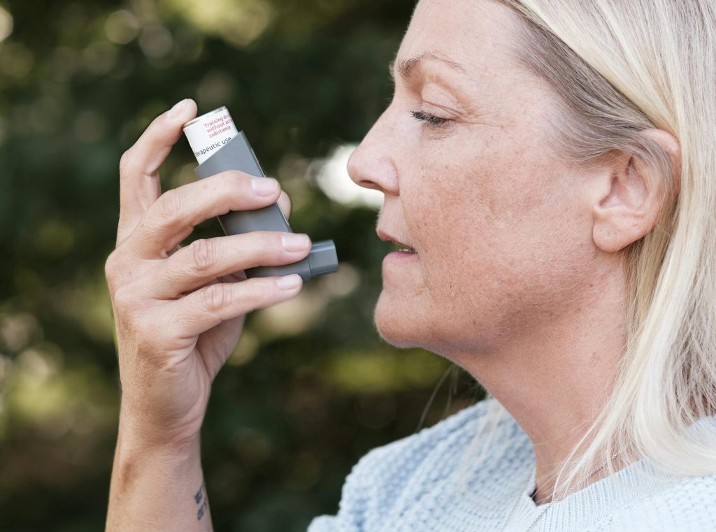 woman using inhaler for respiratory health